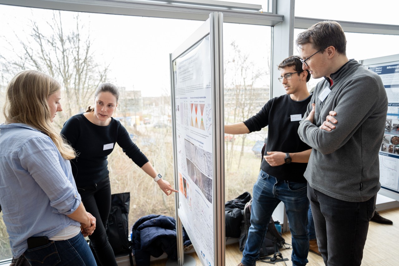 Scientists discussing at a poster session.