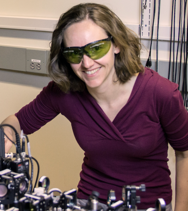 Cindy Regal Cindy Regal with laser protection glasses bending over an experiement