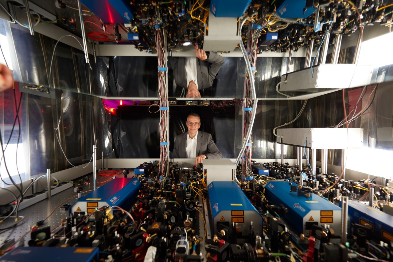 Immanuel Bloch over a laser table top in a laboratory. 