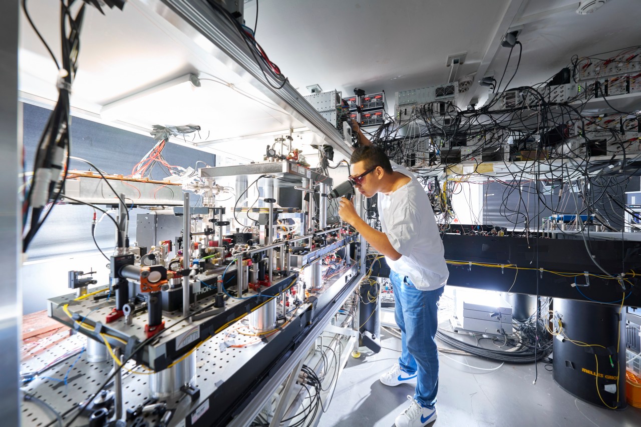 Physicist checks the experimental setup in an quantum communication laboratory. 