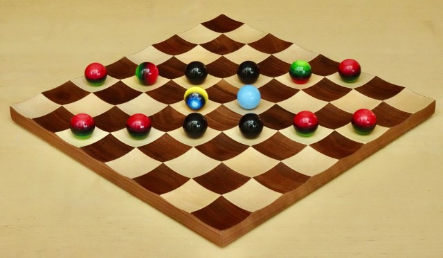 The Quantum Bead Game played with hand-painted spheres on a chess board.