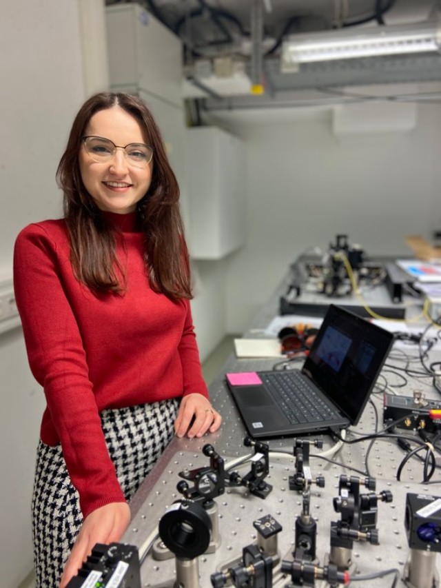 Linda Qerimi standing next to a table in the students laboratory. 