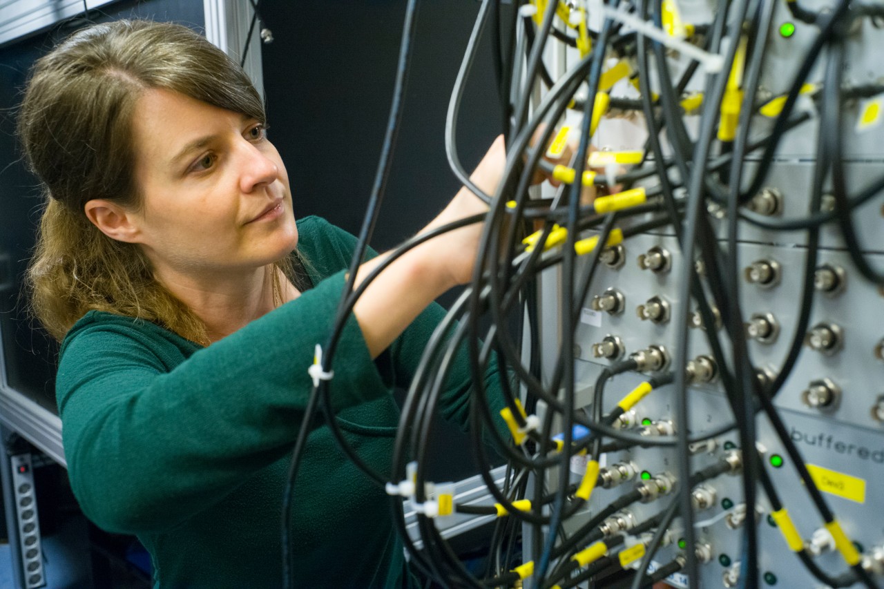 Monika Aidelsburger  Female researcher working in a quantum laboratory.