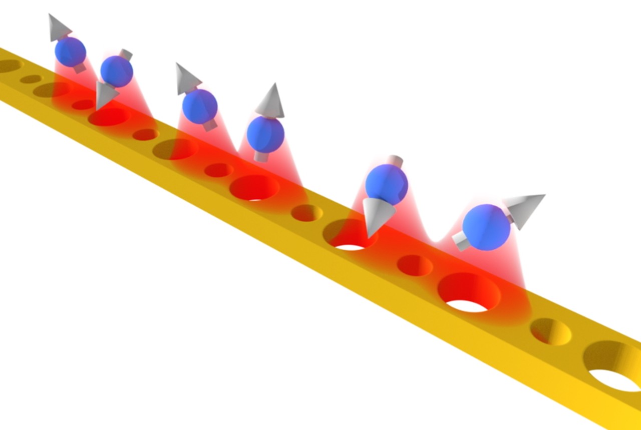 Artistic view of the atoms that work as qubits close to a “topological waveguide”. 
